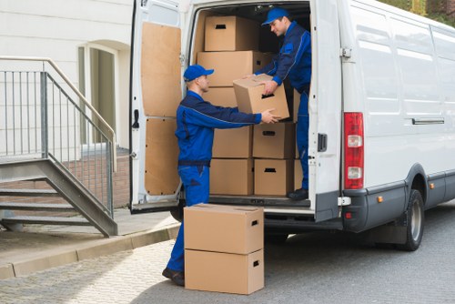Careful loading of student belongings in a Swiss Cottage residential street