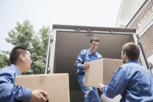 Packed office equipment and furniture ready for transport during a Swiss Cottage business move
