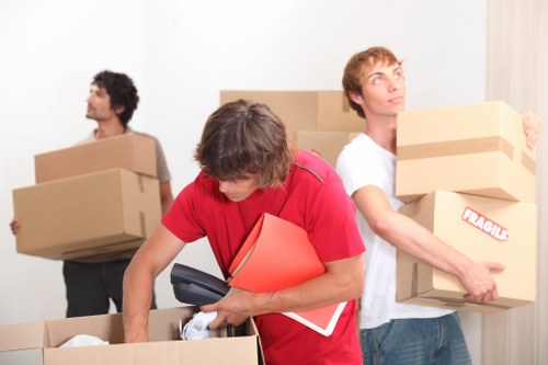 Trained movers handling boxes and furniture carefully