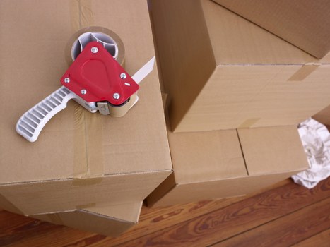 Packed household boxes and furniture prepared for removals in Swiss Cottage