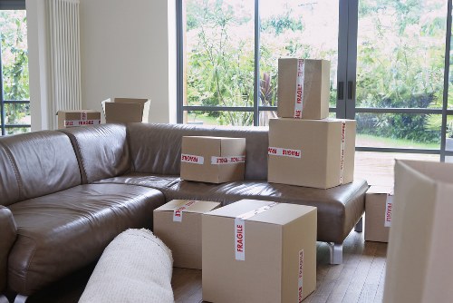 Home removal team loading boxes and furniture near Swiss Cottage apartments
